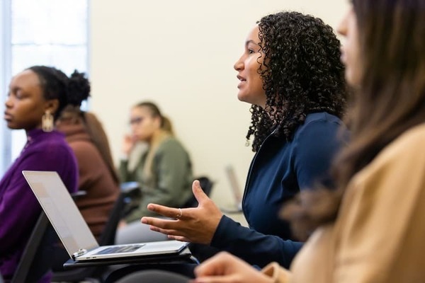 Female presenting student speaking in a black political thought class discussion